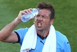 Sydney FC's Milos Dimitrijevic cools off with water bottle
