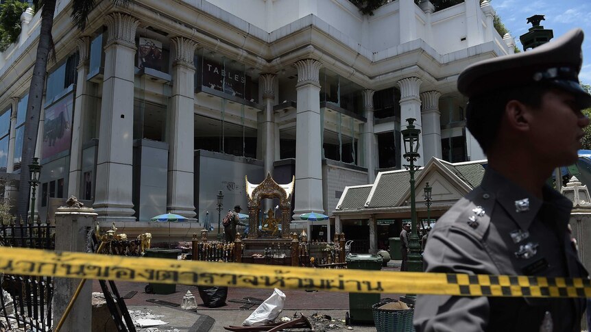 Thai police guard the cordoned-off site of a bomb blast in Bangkok