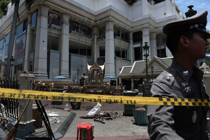 Thai police guard the cordoned-off site of a bomb blast in Bangkok