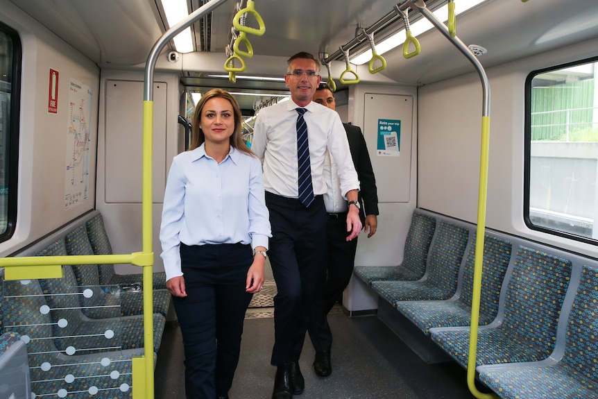 Man and woman standing on train 
