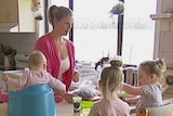 Emily Trimble prepares food for her three young daughters in her kitchen