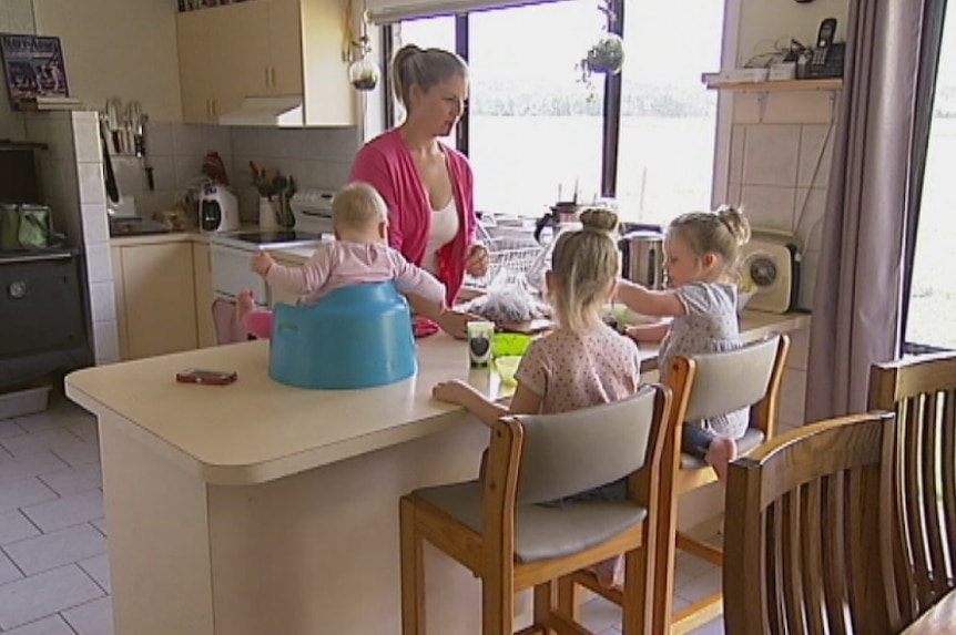 Emily Trimble prepares food for her three young daughters in her kitchen