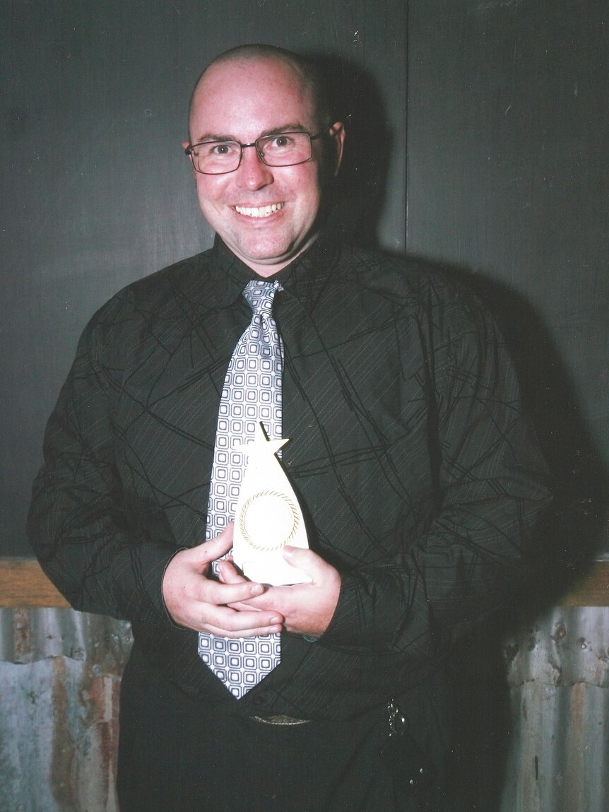 Clinton Vandenberg holding a trophy