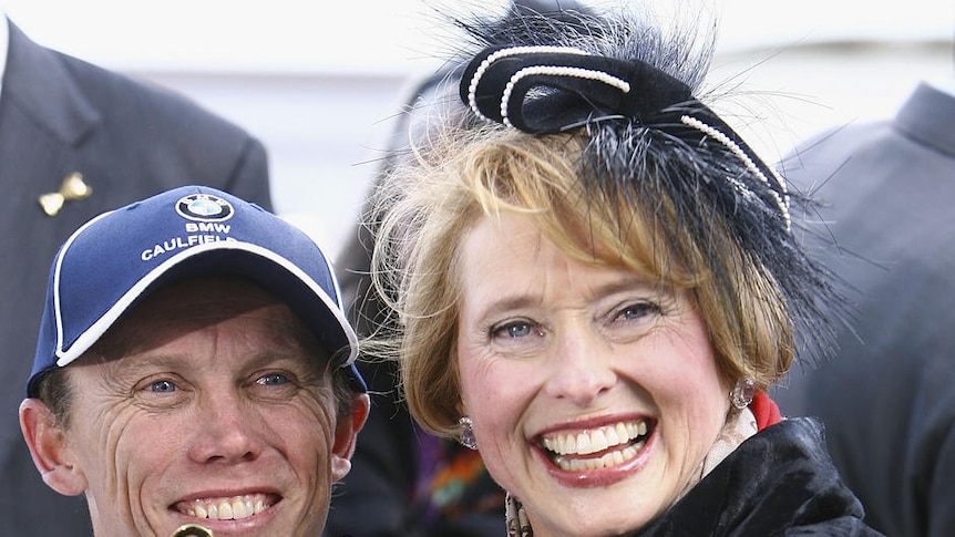 Jockey Chris Munce and trainer Gai Waterhouse celebrate after winning the Caulfield Cup with Descarado