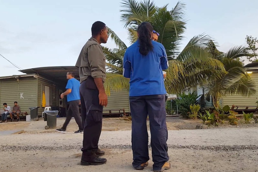 Staff speaks to a detainee