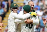 A smiling Nathan Lyon straddles Peter Siddle. Tim Paine, Travis Head and Cameron Bancroft converge to join the celebration