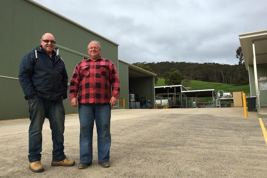 Bruce Watson and Peter Polovinka stand in front of a newly built red meat processing facility in Trafalgar, Victoria.