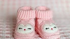 A pair of pink baby booties.