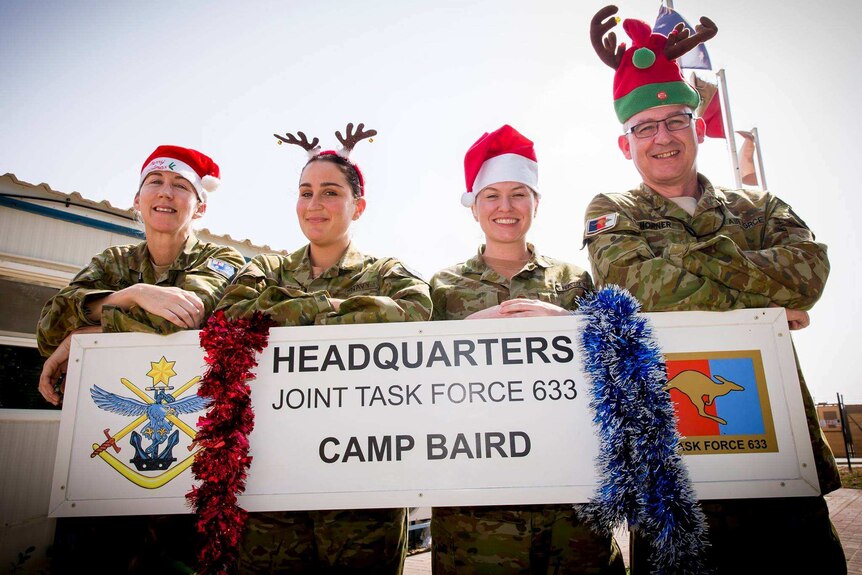 Australian Defence Force members dressed for Christmas at Camp Baird.