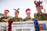 Australian Defence Force members dressed for Christmas at Camp Baird.