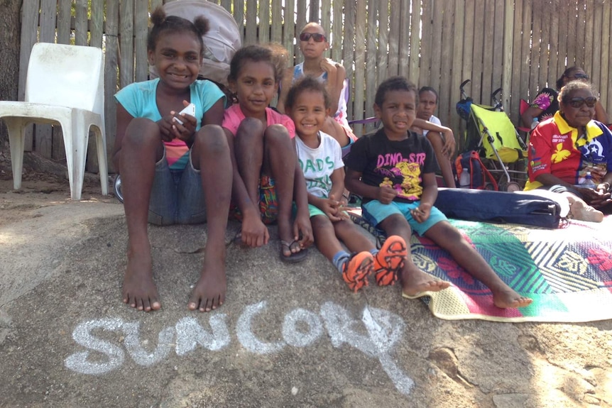Fans sit in 'Suncorp Stadium" on Thursday Island for finals day.