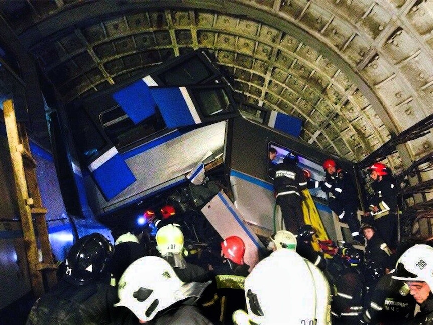 Rescuers work near a derailed subway train in Moscow.