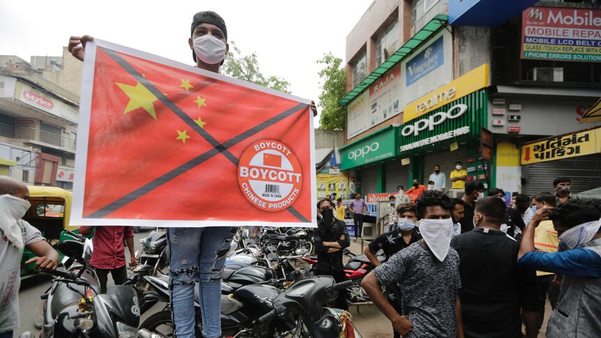 A protester holds a banner calling for the boycott of Chinese products in Ahmedabad, India.