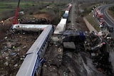 An aerial view of a serious crash between two trains on the same track shows carriages at a 90-degree angle.