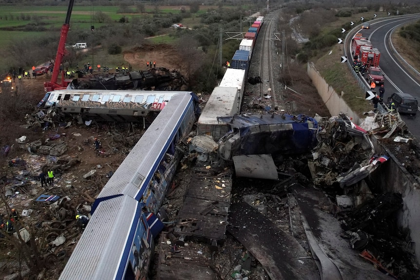 An aerial view of a serious crash between two trains on the same track shows carriages at a 90-degree angle.