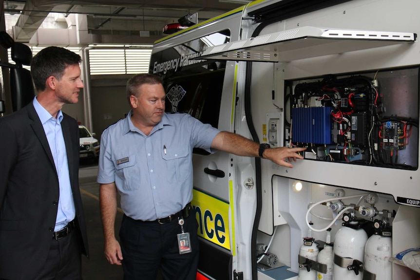 Brad Hardy shows Mark Bailey EVP technology in an ambulance