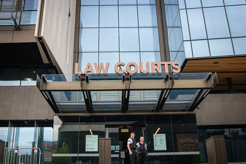 A view of the entrance to the law courts with security guards posted outside.