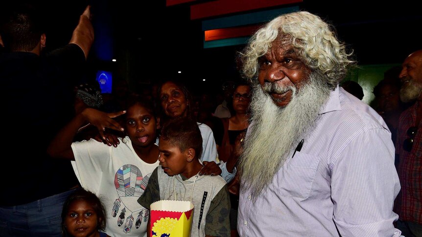 Gibson John and young Aboriginal kids gather in the cinema foyer at the preview screening of Sweet Country