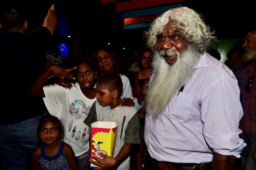 Gibson John and young Aboriginal kids gather in the cinema foyer at the preview screening of Sweet Country