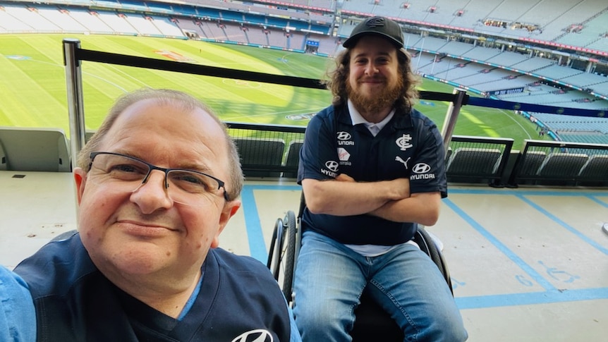 Two men in wheelchairs in accessibility zone on level four of the MCG