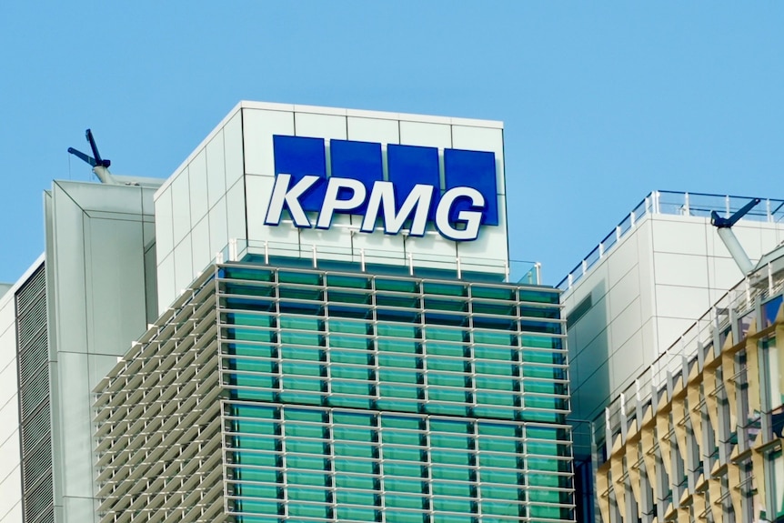 A logo on top of a building with white letters that read KPMP with a blue background.