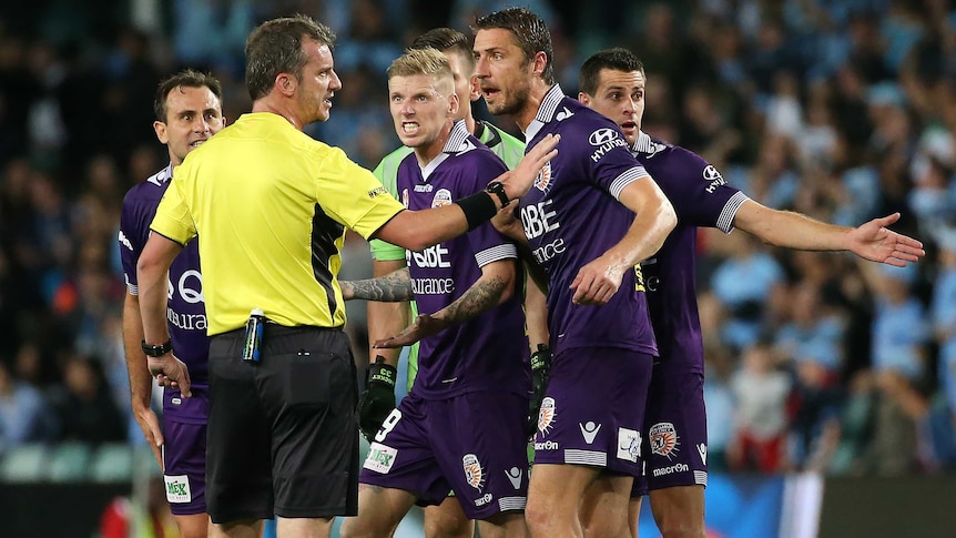 Perth Glory players argue with referee Peter Green in A-League semi-final