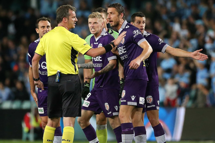 Perth Glory players argue with referee Peter Green in A-League Semi Final against Perth Glory.