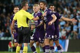 Perth Glory players argue with referee Peter Green in A-League semi-final