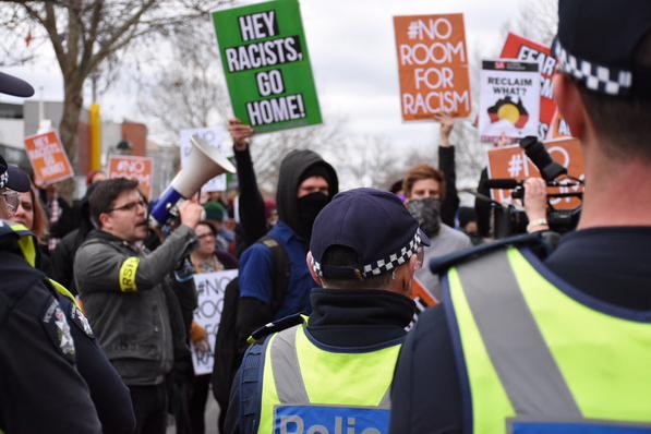 Hey racists go home sign at Bendigo protest