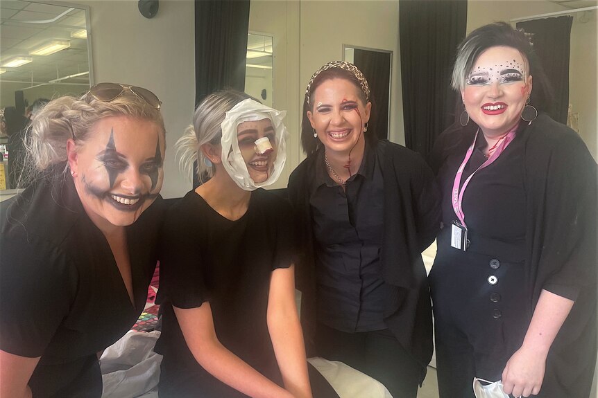 Four women in Halloween makeup looks.