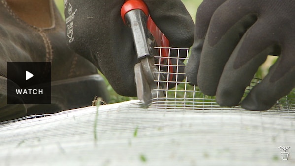 Wire mesh being cut with wire cutting snips. Has Video.