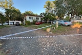 crime scene tape around single-storey home