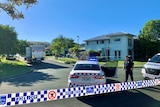 Police outside a home on a sunny day