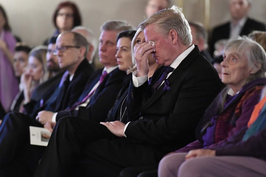 A man cries at the state memorial for Fiona Richardson.