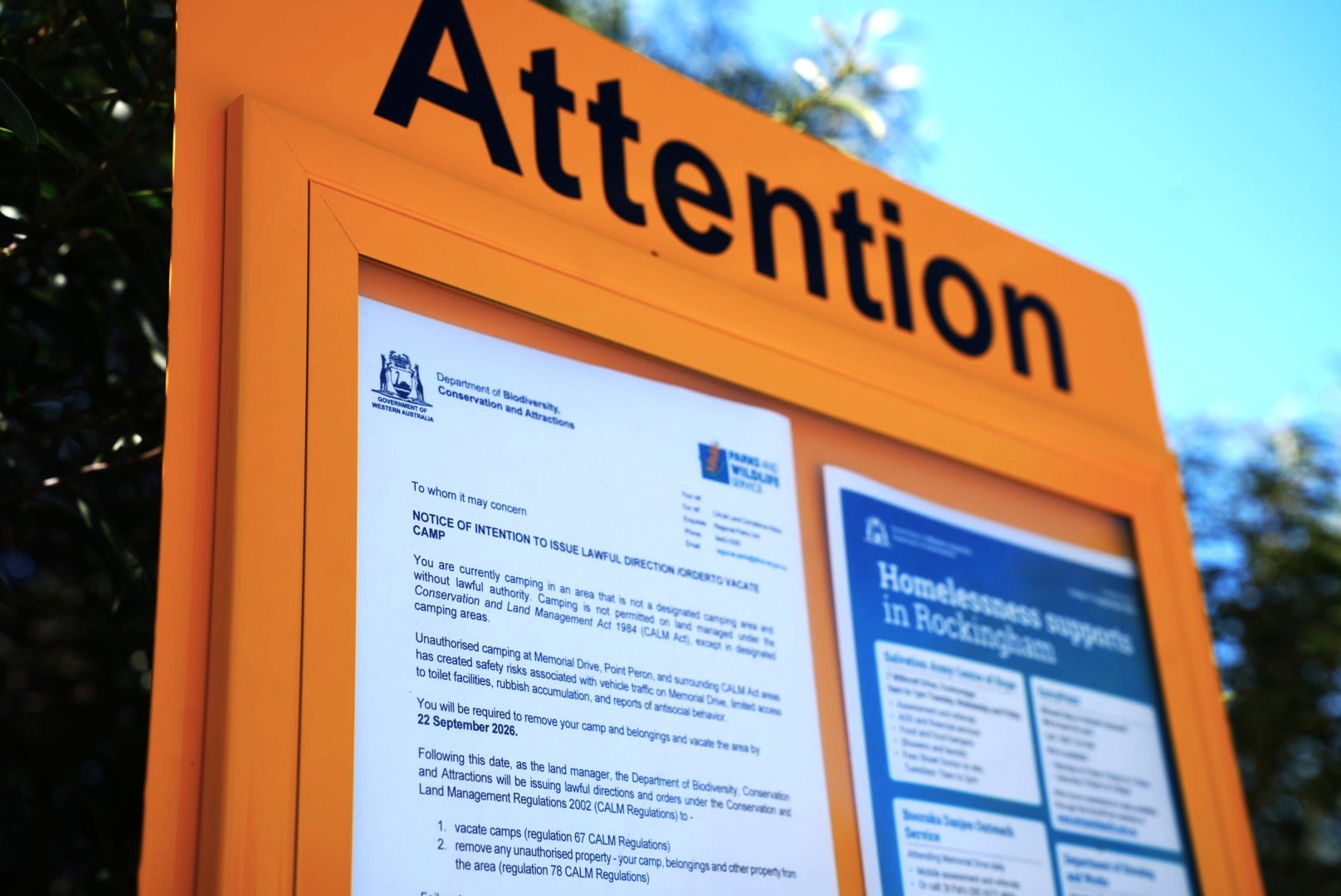 Orange signpost with letter.