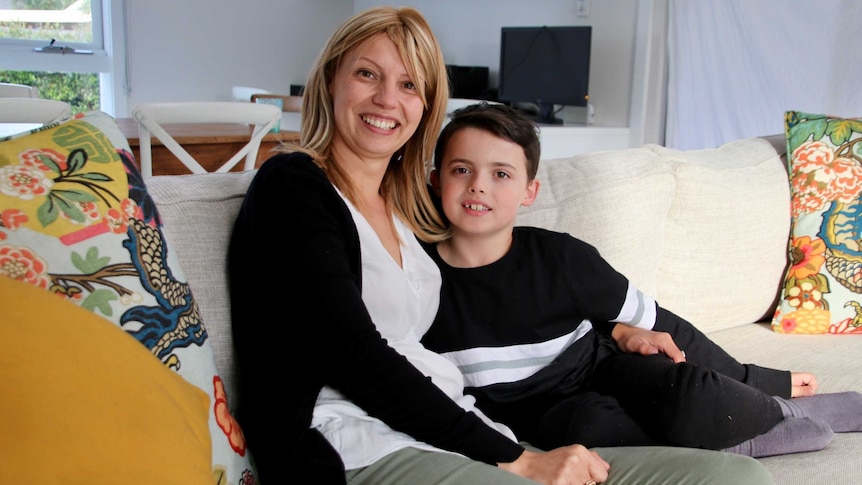 Mother and son sitting on a couch