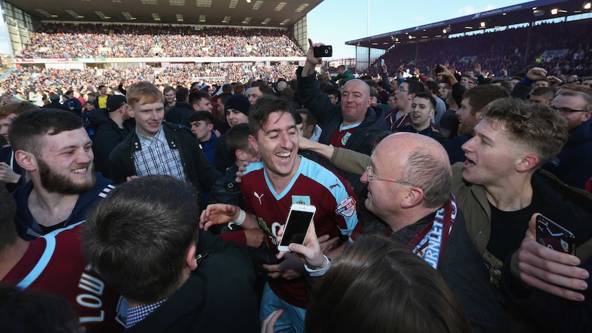 Stephen Ward celebrates with fans after Burnley promotion