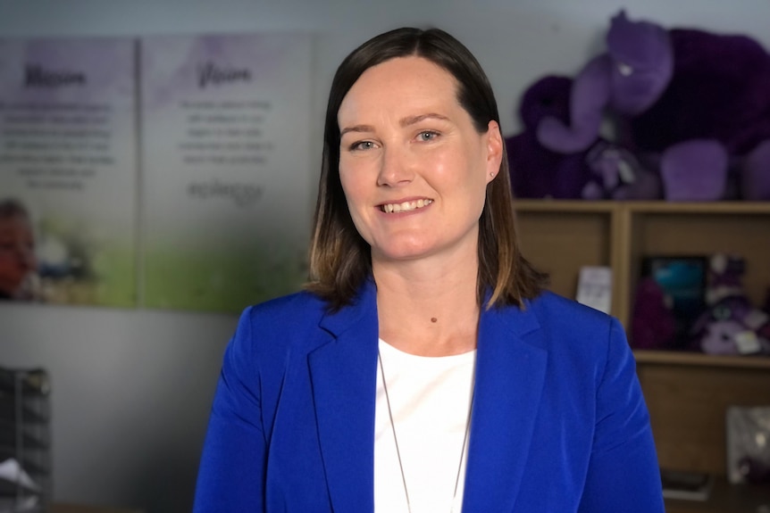 Epilepsy ACT chief executive Fiona Allardyce  smiling at the camera, wearing a blue blazer in an office