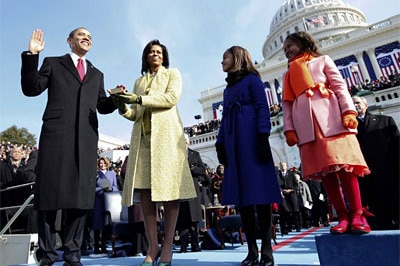 Barack Obama taking the Oath of Office as his wife Michelle and daughters look on