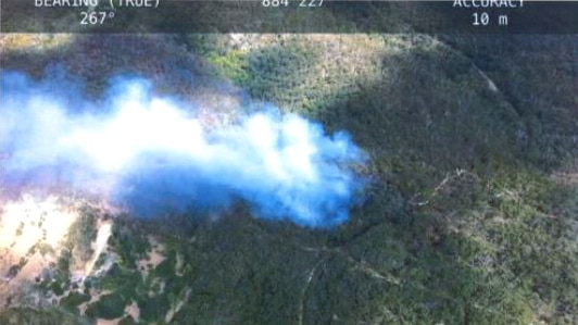 Smoke rises from the Belair National Park, as seen from above.