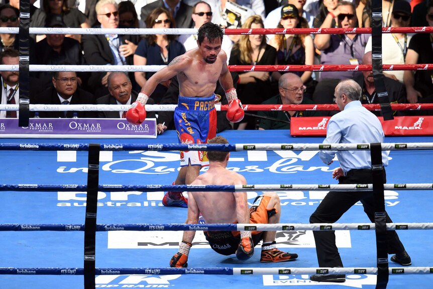 Manny Pacquiao stands over Jeff Horn