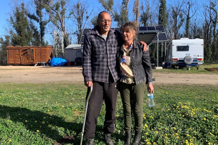 Mark and jane outside their temporary home