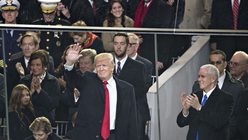 U.S. President Donald Trump, left, is applauded by U.S. Vice President Mike Pence, right.