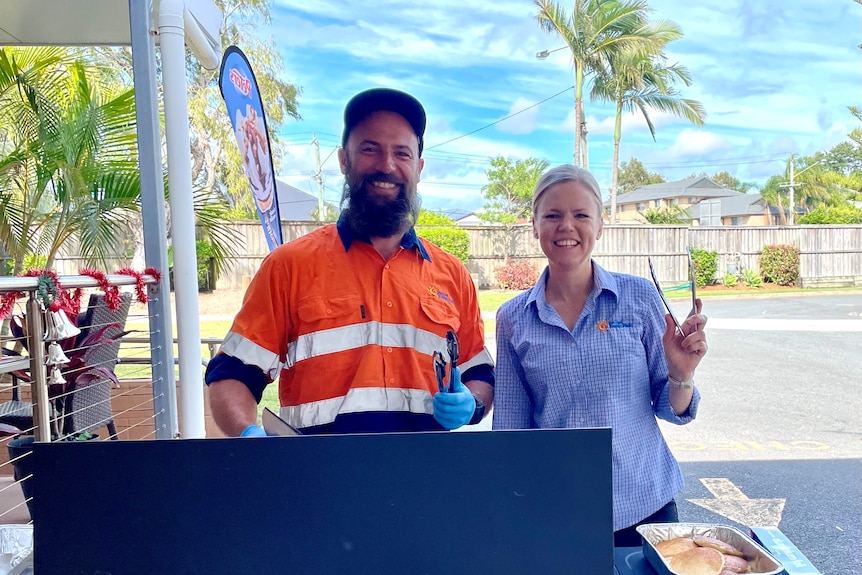 Photo of Shannon Deere and another staff member cooking a bbq.