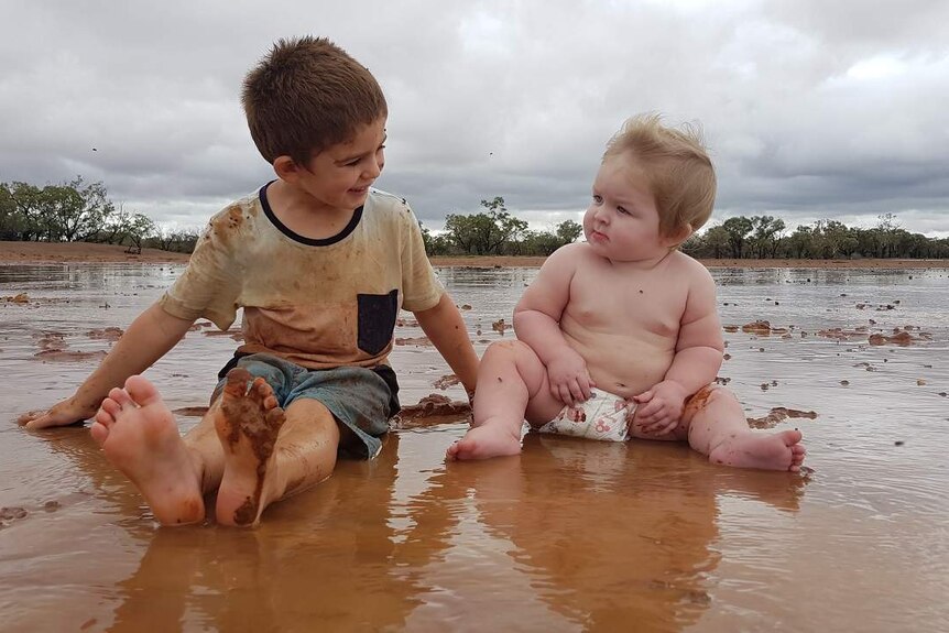 Mariah Powyer's sons Dean and Riley play in the mud