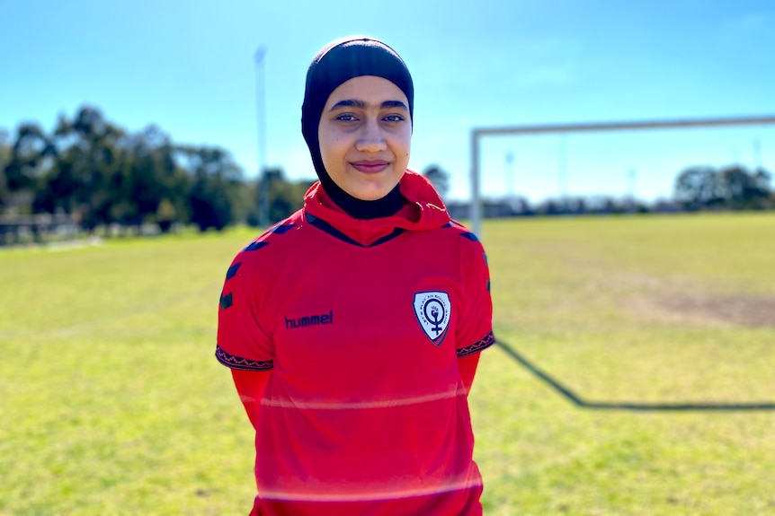 Woman dressed in red on soccer field