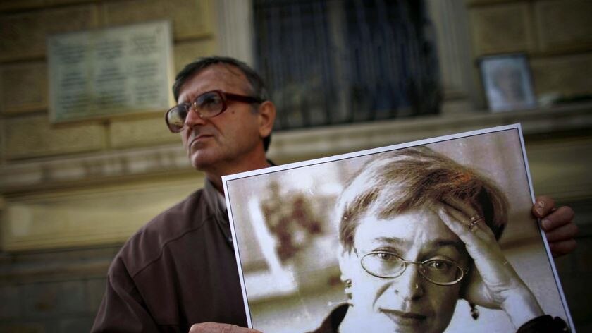 A protester holds a picture of murdered Russian journalist Anna Politkovskaya