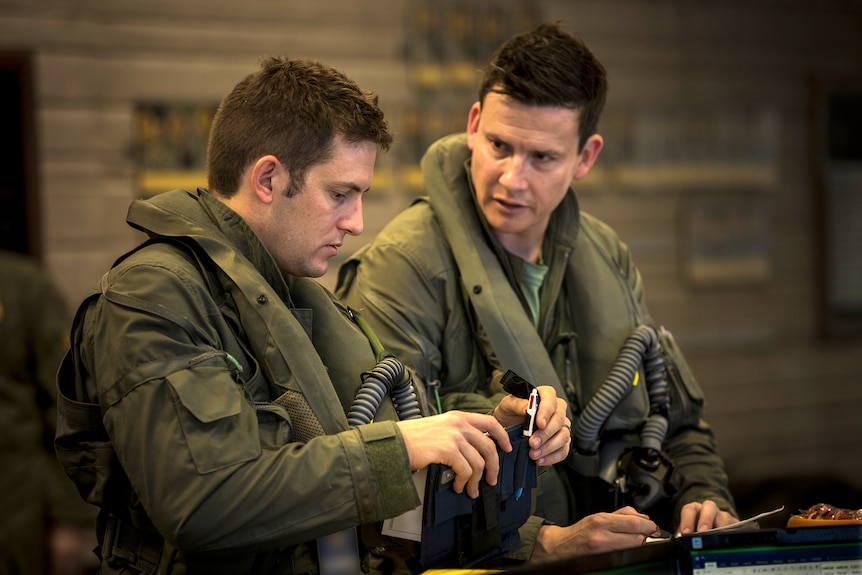 Fighter pilots prepare for a training mission