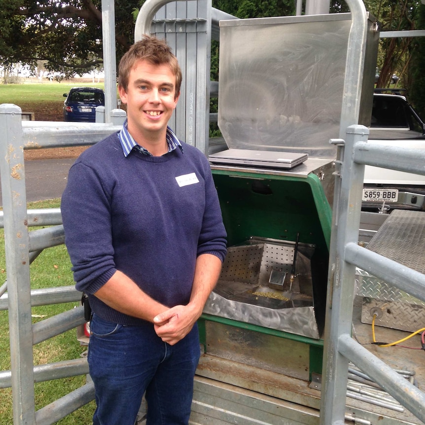 Dr Michael Wilkes stands in front of the Green Feeder Machine, which analyses cattle breath for methane emissions.