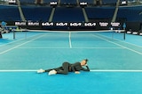 Heather Watson reclining on a tennis court.